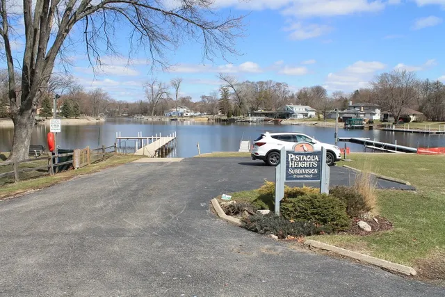 a swimming pool with outdoor seating and yard