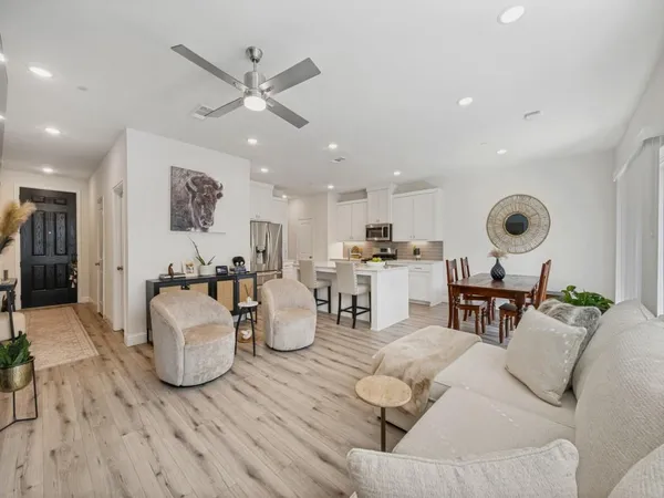 a living room with furniture and kitchen view