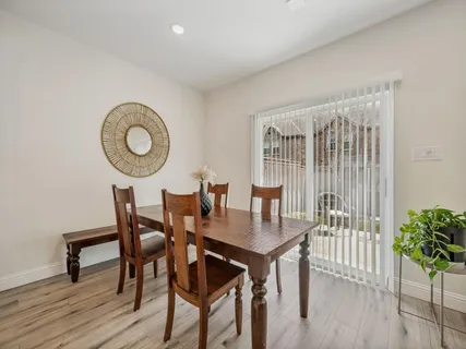 a dining room with furniture and wooden floor