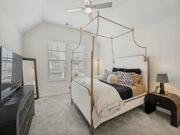 a bedroom with a bed window and a flat screen tv