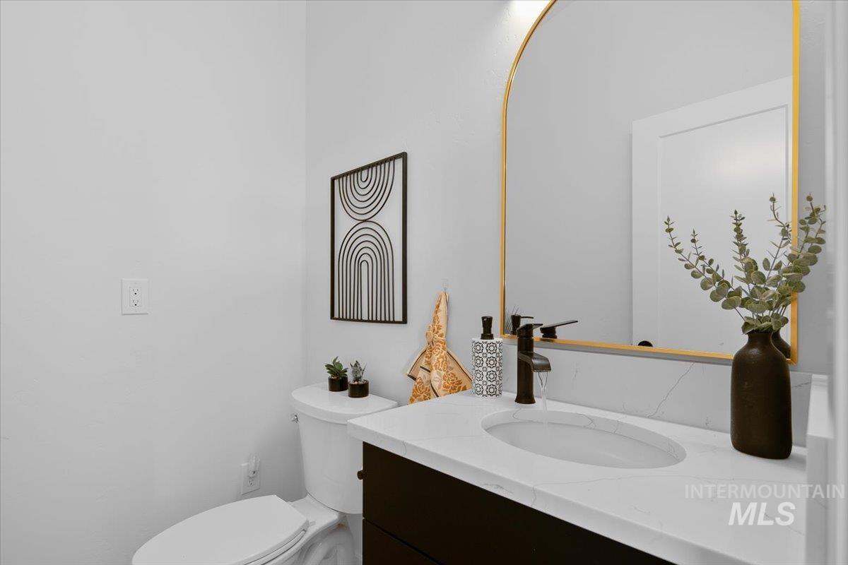 8365 Rustin Road Middleton, ID 83644 - Photo 13 of 48 Half bathroom featuring vanity and toilet