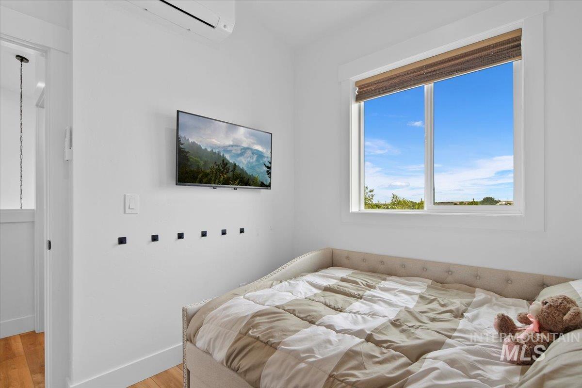 8365 Rustin Road Middleton, ID 83644 - Photo 15 of 48 Bedroom or Office featuring with light LVP flooring and a wall unit AC