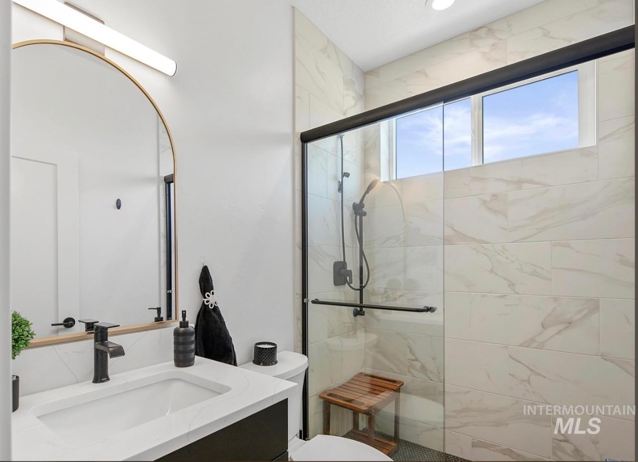 8365 Rustin Road Middleton, ID 83644 - Photo 31 of 48 Full bath with vanity and a marble finish shower