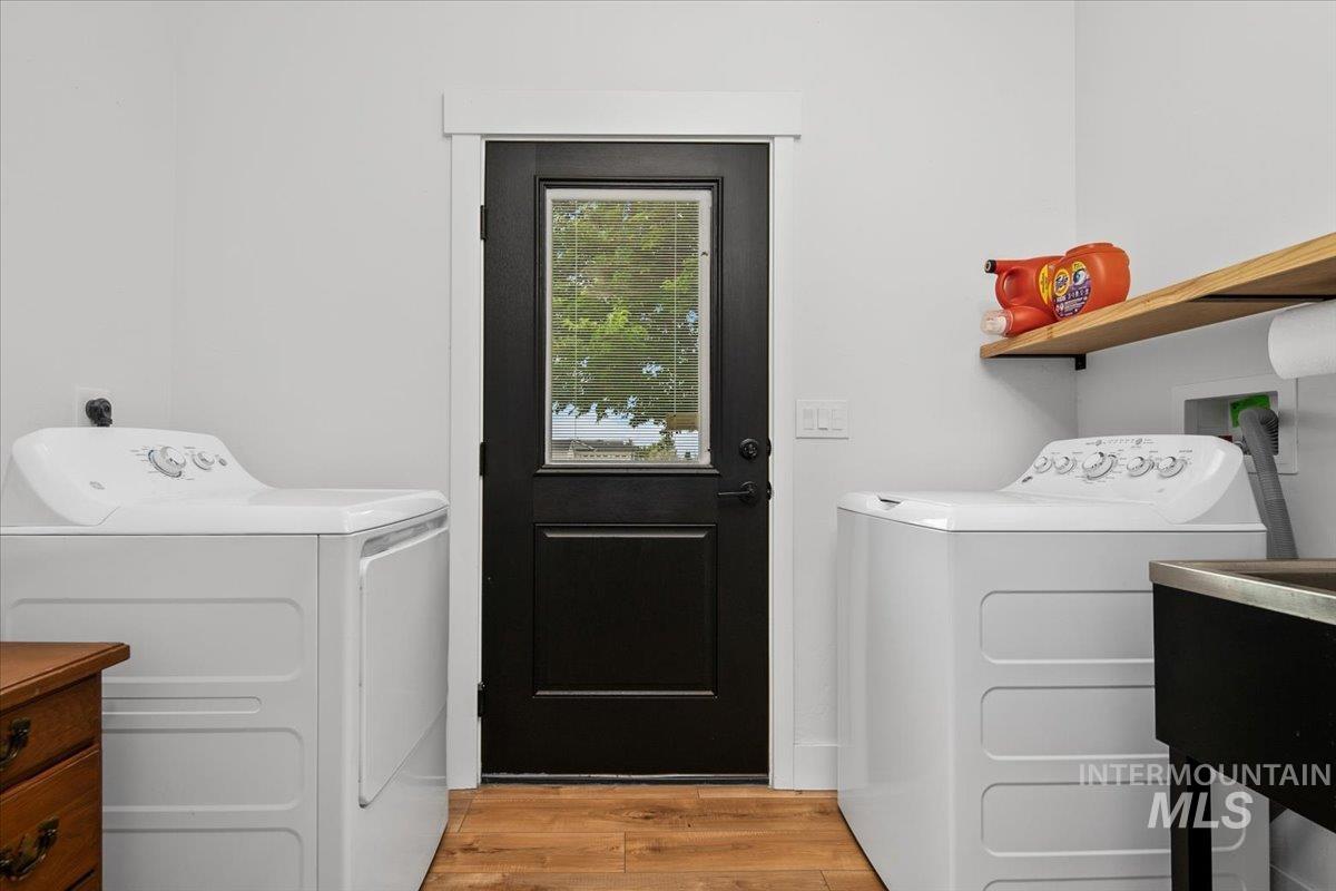 8365 Rustin Road Middleton, ID 83644 - Photo 32 of 48 Washroom featuring washer and dryer and light wood-type flooring, outdoor access and utility sink.