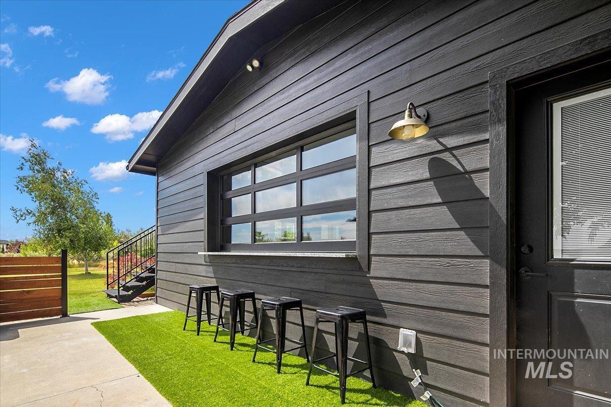 8365 Rustin Road Middleton, ID 83644 - Photo 35 of 48 View of property exterior with a yard and a patio area off of the pool room.
