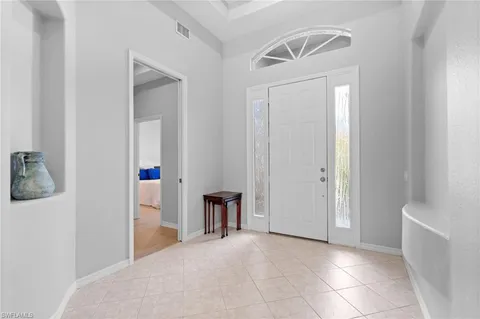 a view of empty room with a white walls