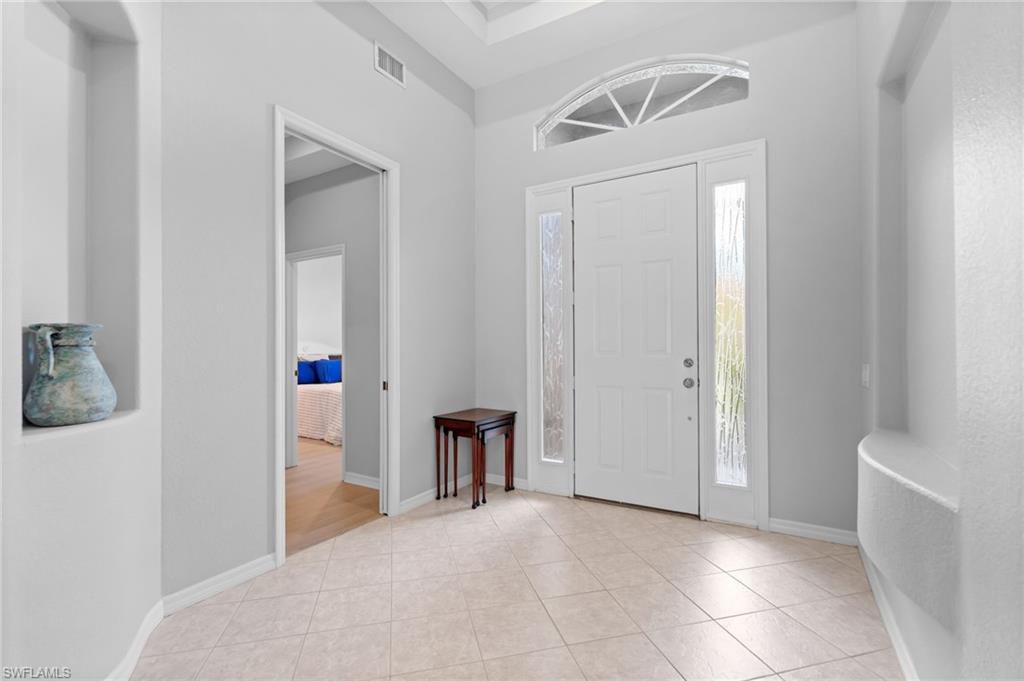 1717 Winding Oaks Way Naples, FL 34109 - Photo 4 of 29 a view of empty room with a white walls