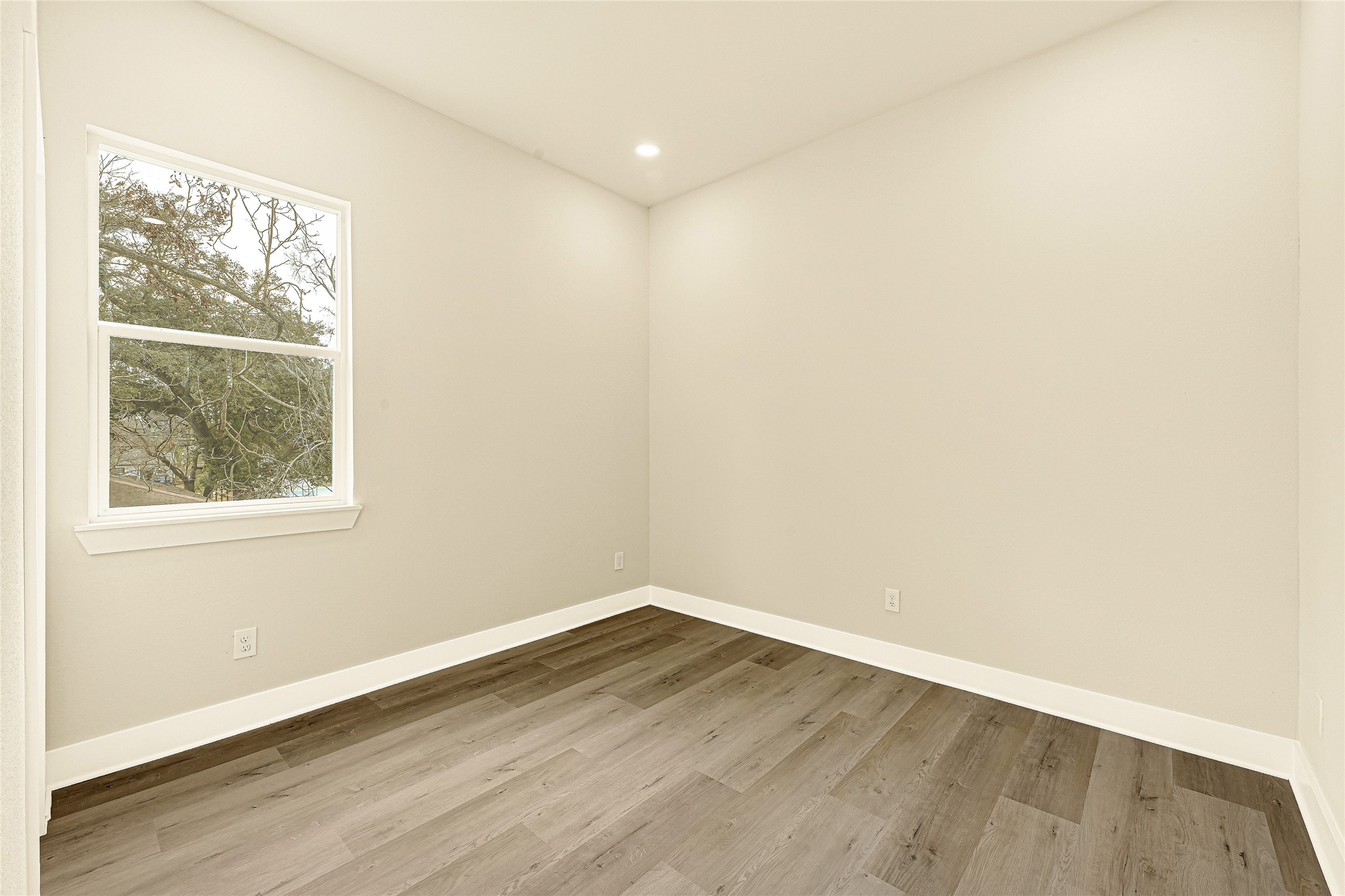 706 Savonna Houston, TX 77076 - Photo 13 of 26 an empty room with wooden floor and windows