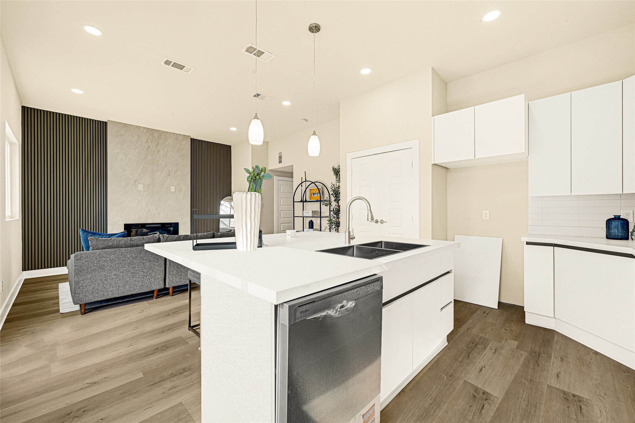 706 Savonna Houston, TX 77076 - Photo 9 of 26 a kitchen with a sink a stove a refrigerator and white cabinets