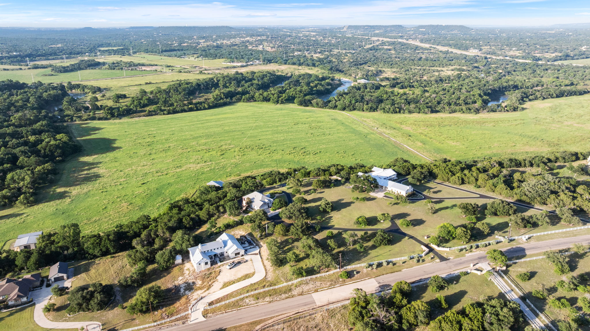 1427 River Ridge Ranch Road Killeen, TX 76549 - Photo 35 of 40 Sprawling verdant acreage unfolds beneath, bordered by a tranquil river and dotted with elegant homes.