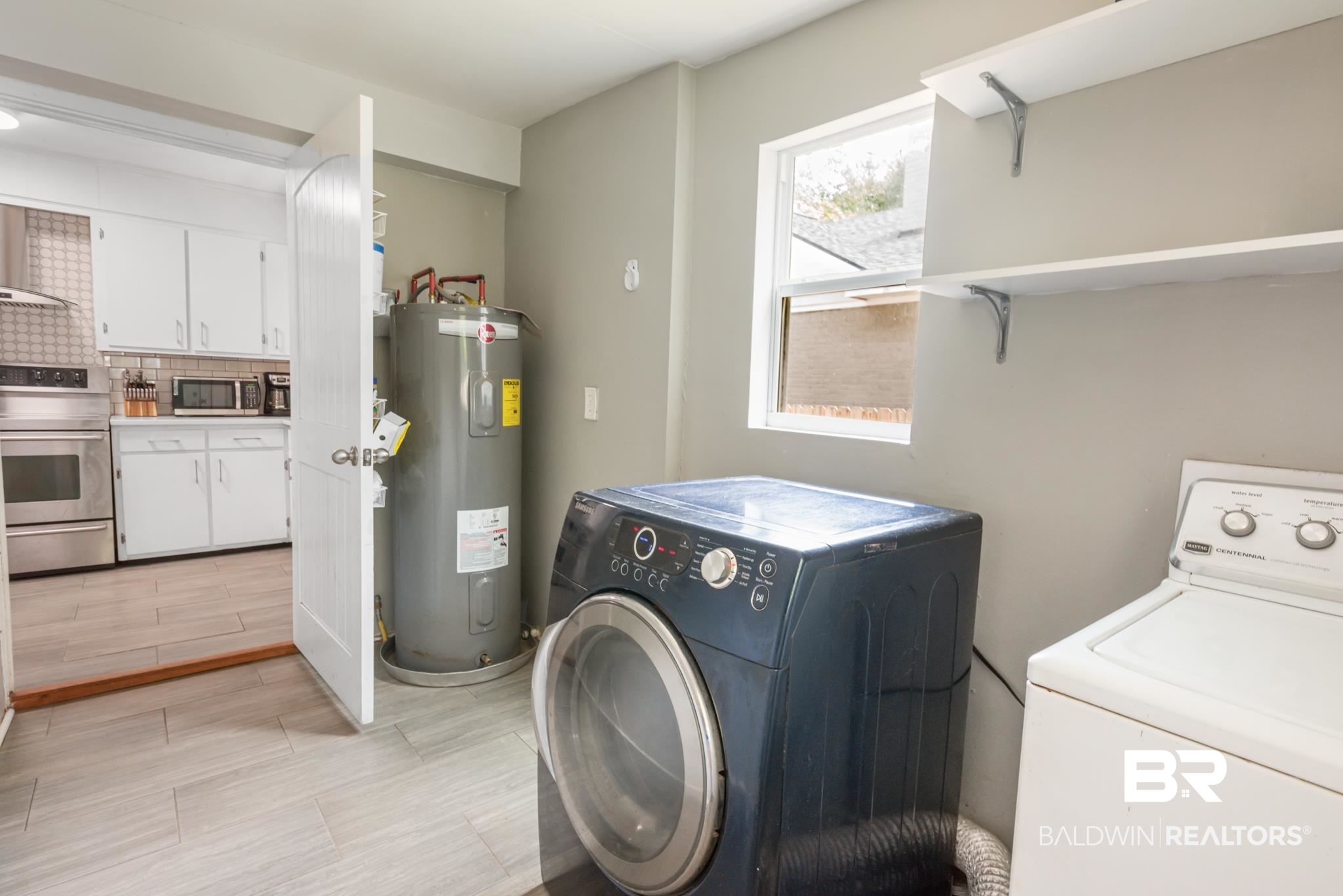 114 Crenshaw Street Mobile, AL 36606 - Photo 26 of 49 Washroom with electric water heater, light tile patterned flooring, and washing machine and clothes dryer