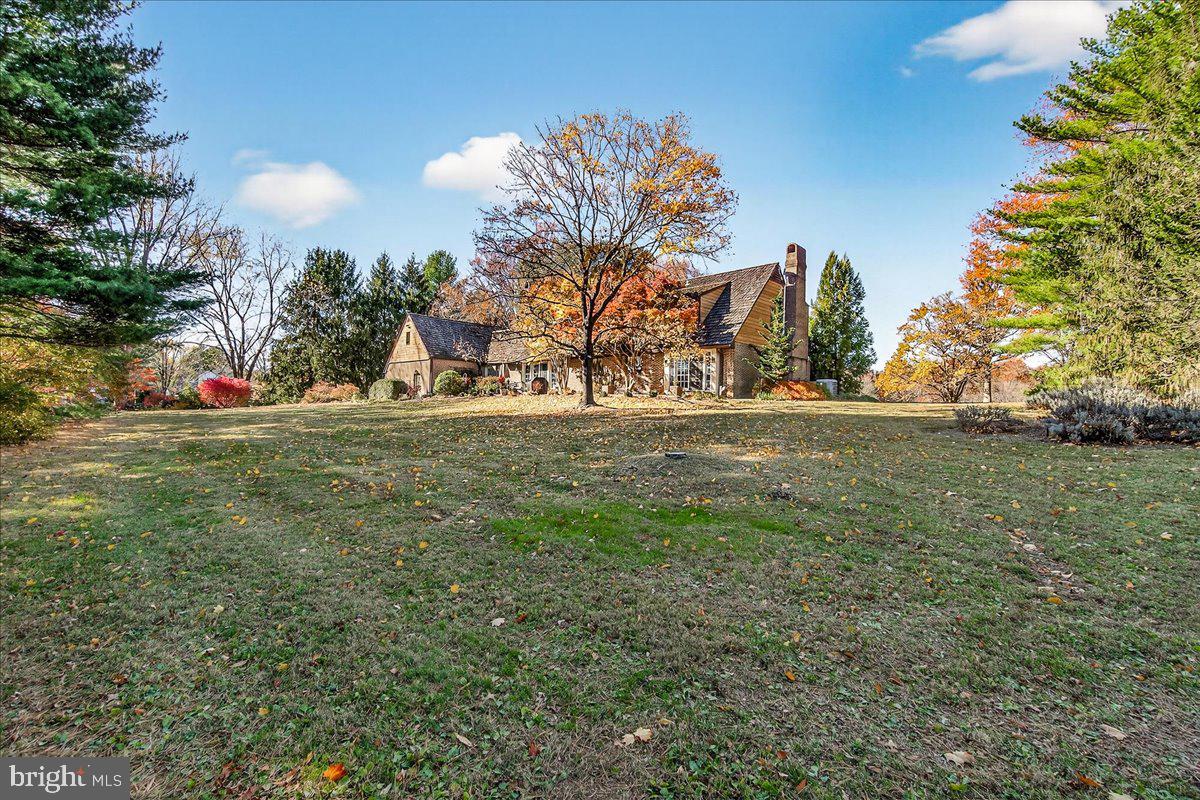 6400 Griffith Road Gaithersburg, MD 20882 - Photo 2 of 70 a view of yard in front of house with trees all around