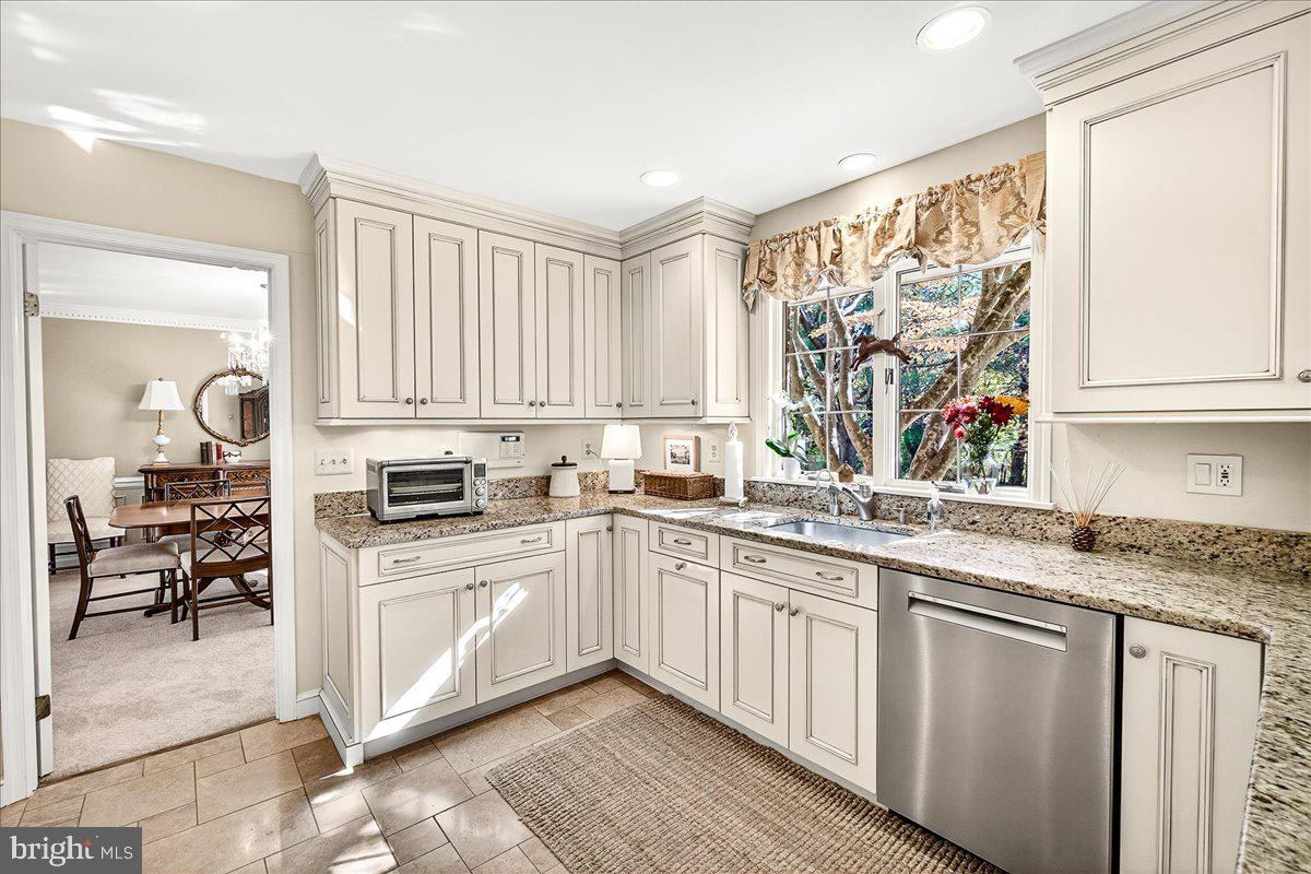6400 Griffith Road Gaithersburg, MD 20882 - Photo 23 of 70 a kitchen with a sink stove and cabinets