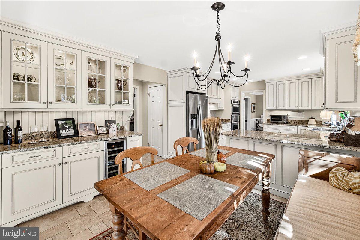 6400 Griffith Road Gaithersburg, MD 20882 - Photo 27 of 70 a view of a dining room and livingroom with furniture wooden floor a chandelier