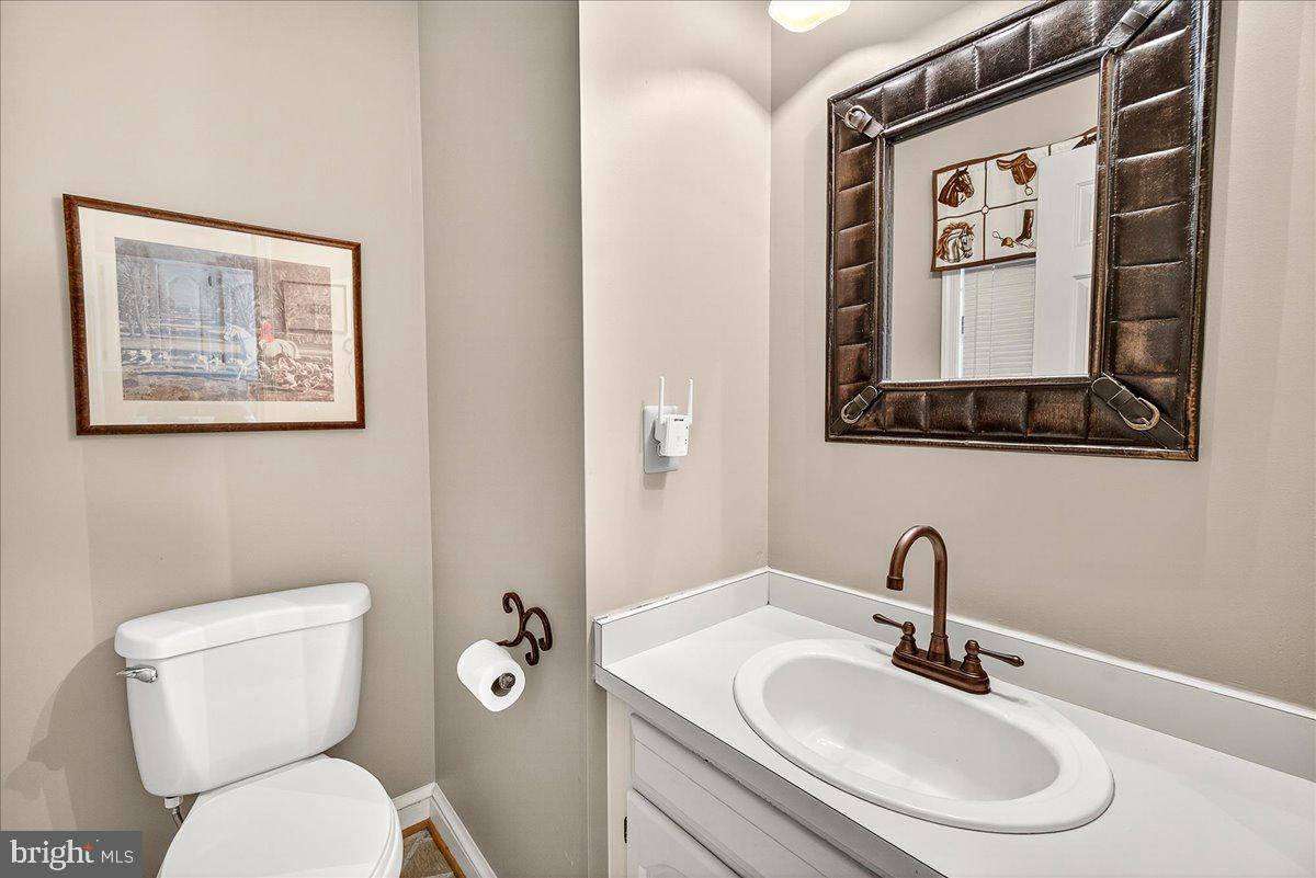6400 Griffith Road Gaithersburg, MD 20882 - Photo 34 of 70 a bathroom with a toilet a sink and mirror