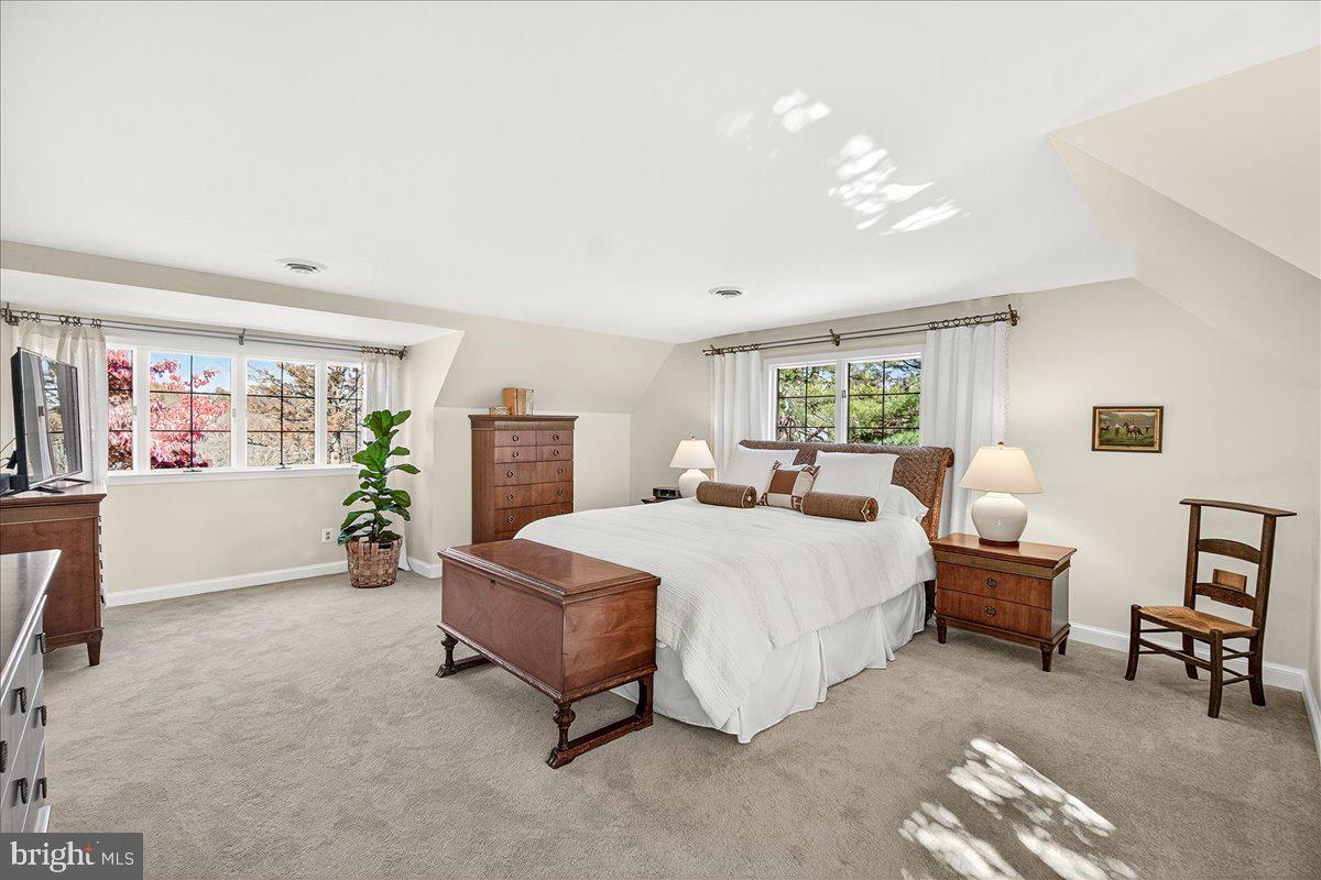 6400 Griffith Road Gaithersburg, MD 20882 - Photo 36 of 70 a spacious bedroom with a bed and a couch