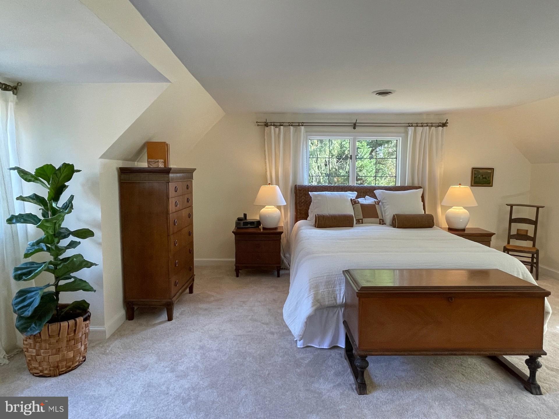 6400 Griffith Road Gaithersburg, MD 20882 - Photo 37 of 70 a bedroom with a bed and a potted plant