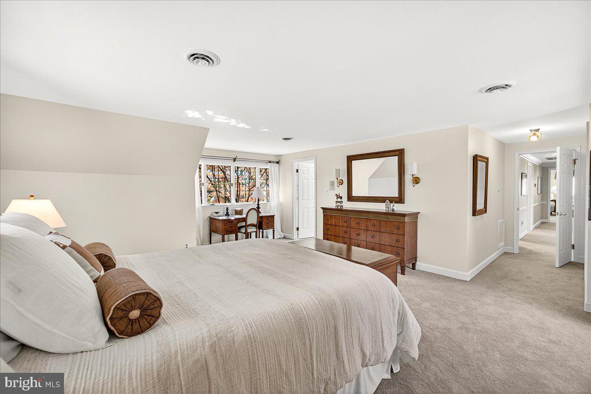 6400 Griffith Road Gaithersburg, MD 20882 - Photo 38 of 70 a bedroom with a bed and a chair