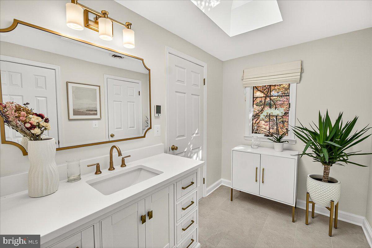 6400 Griffith Road Gaithersburg, MD 20882 - Photo 40 of 70 a bathroom with double vanity sinks a mirror and a potted plant