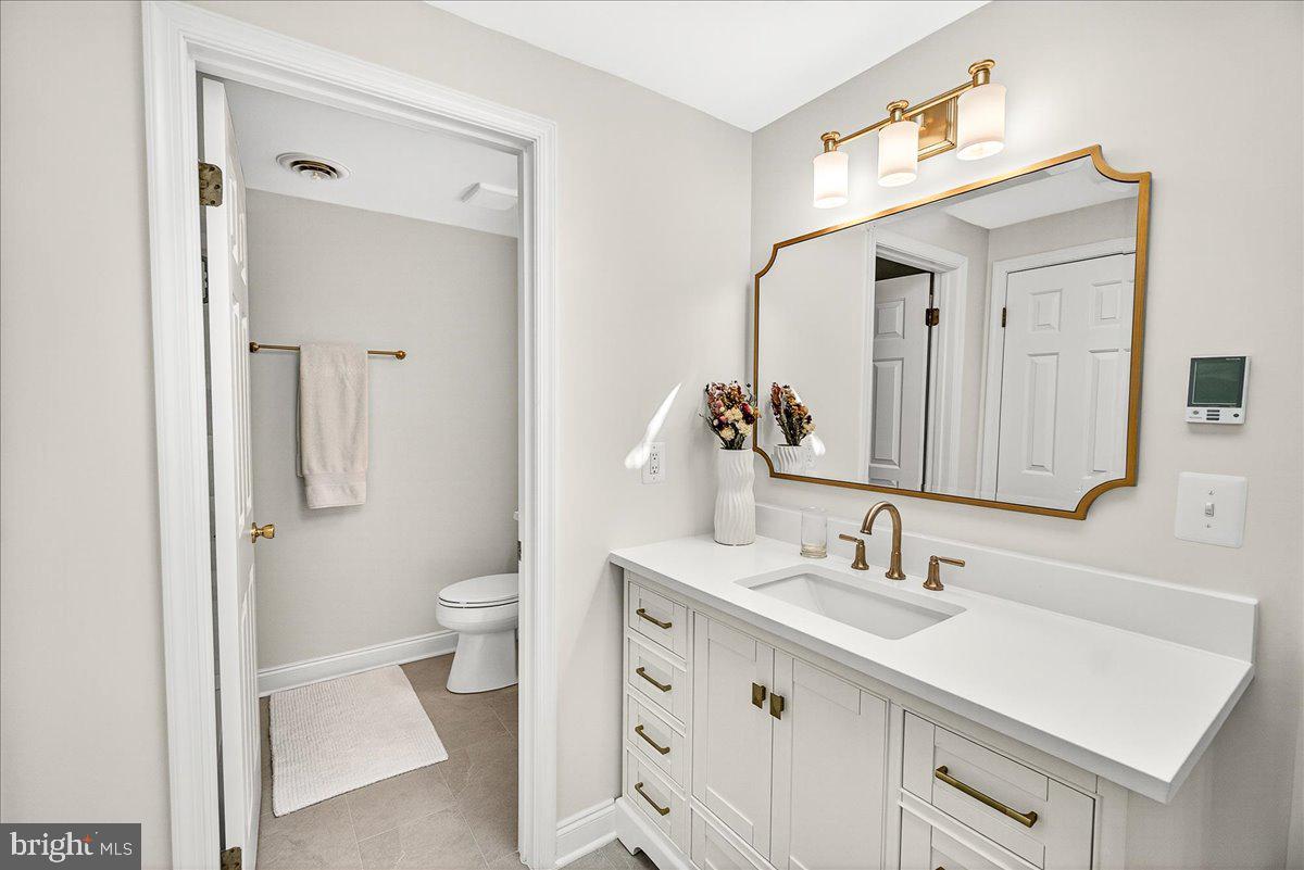 6400 Griffith Road Gaithersburg, MD 20882 - Photo 41 of 70 a bathroom with a sink a toilet and shower