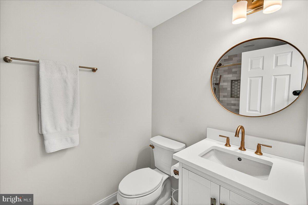 6400 Griffith Road Gaithersburg, MD 20882 - Photo 42 of 70 a white toilet sitting next to a bathroom sink