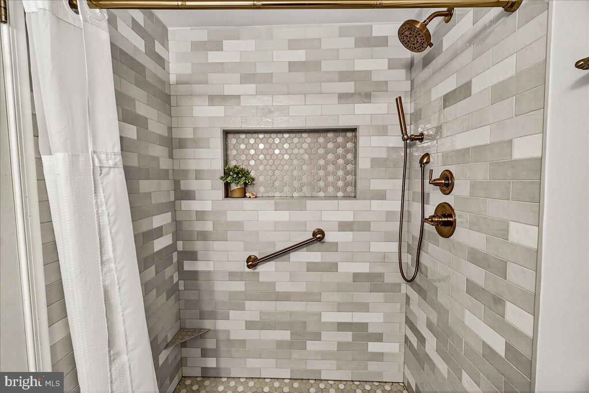 6400 Griffith Road Gaithersburg, MD 20882 - Photo 43 of 70 New Tiled Shower with recessed shelf
