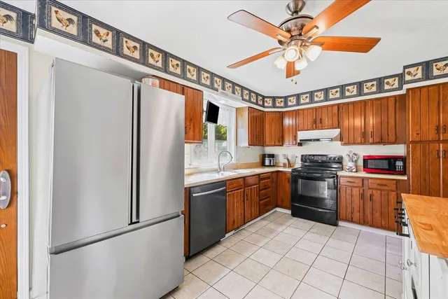 a kitchen with stainless steel appliances granite countertop a refrigerator and a sink