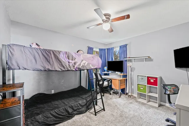 a workspace with furniture window and a ceiling fan