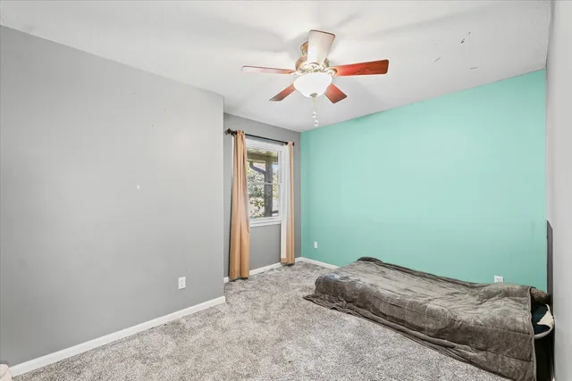 a bedroom with a large bed and a chandelier