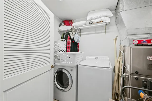 a view of a house with a small yard and a garage