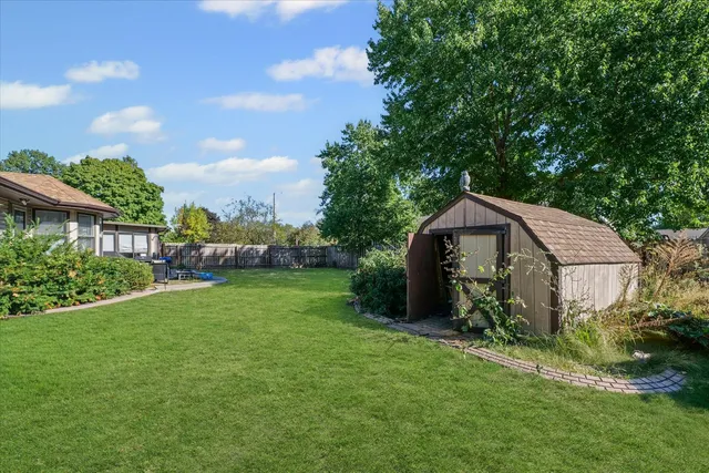 a view of a house with backyard and sitting area