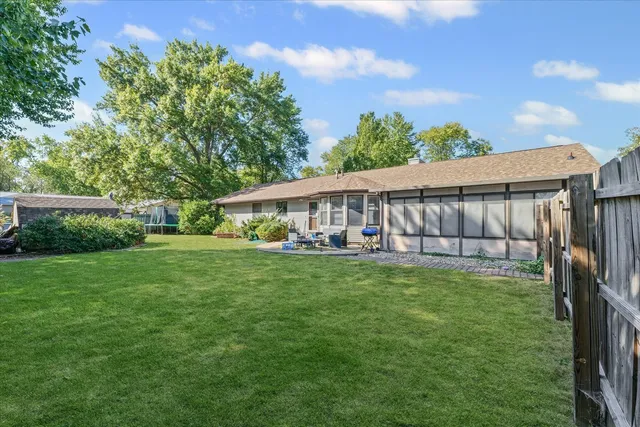 a view of a house with backyard sitting area and garden