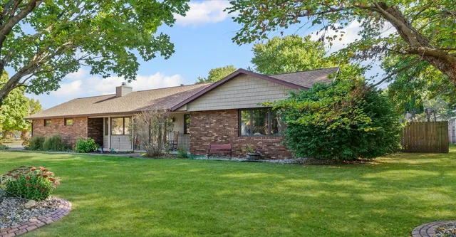 a front view of a house with a garden and yard