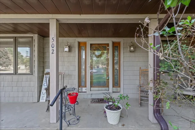 a view of an entryway with wooden floor