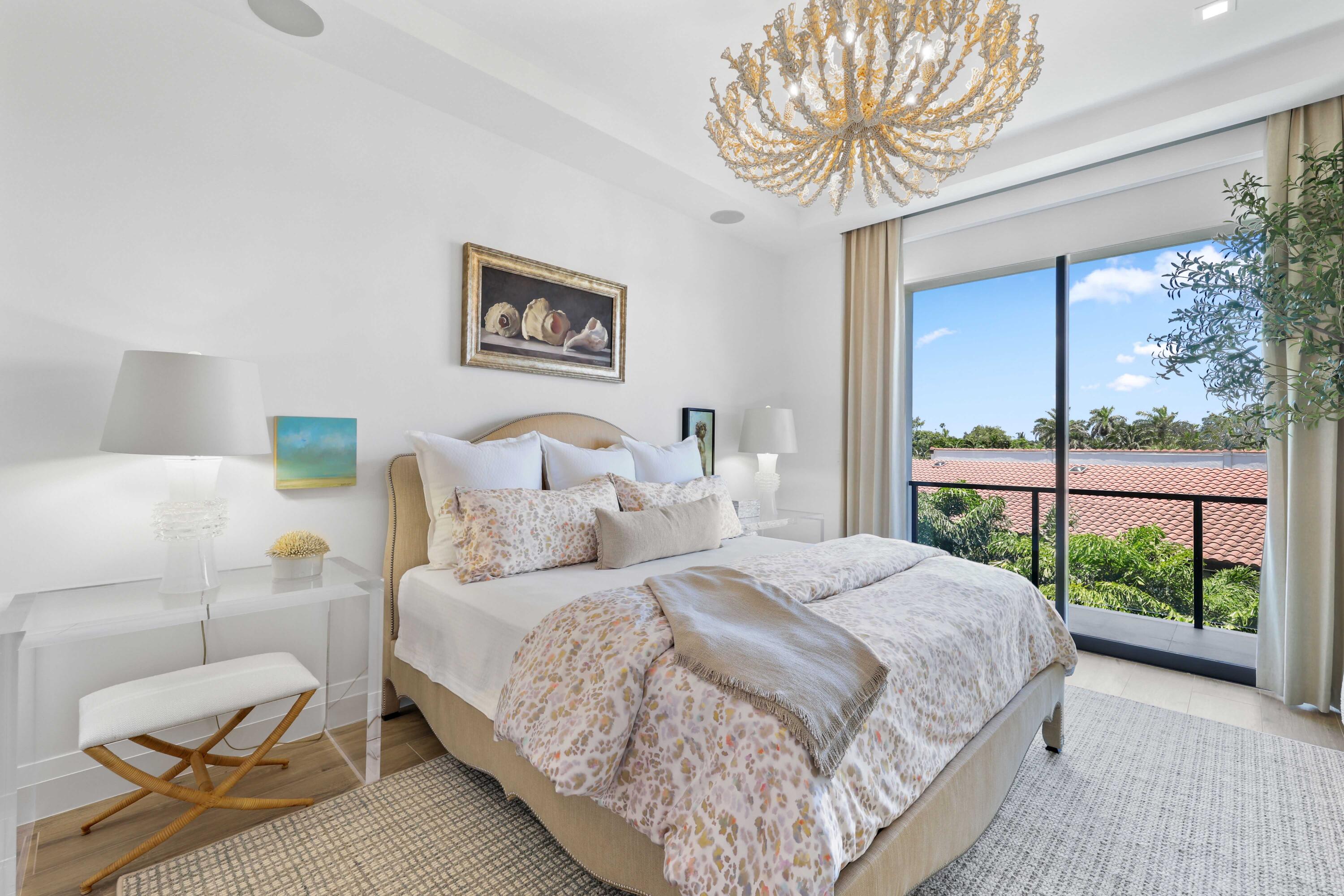 1177 George Bush Boulevard, Unit 306 Delray Beach, FL 33483 - Photo 25 of 66 a bedroom with a large bed and a chandelier