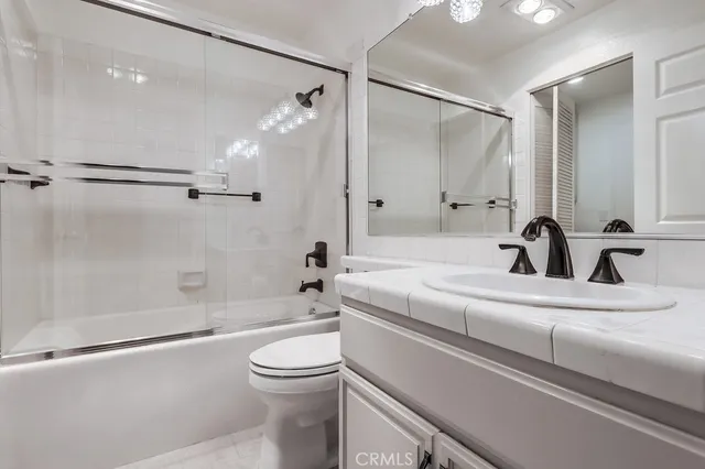 a bathroom with a sink a toilet and a bathtub