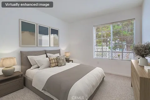 a bedroom with a large bed and a large window