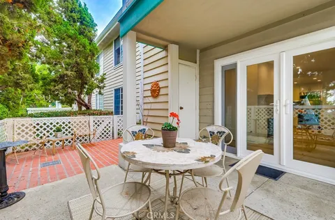a view of a patio with a table and chairs