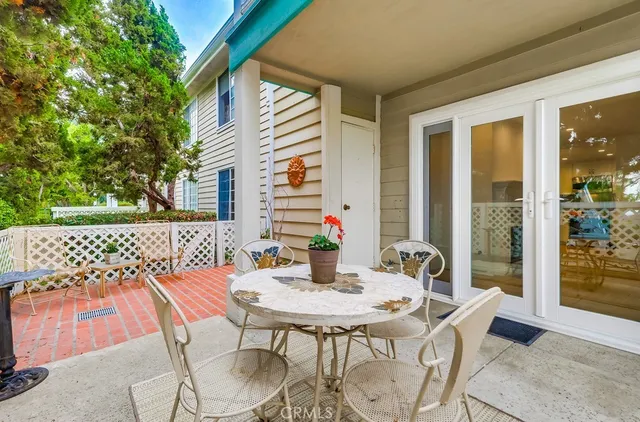 a view of a patio with a table and chairs
