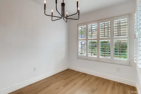 a view of a room with wooden floor and windows