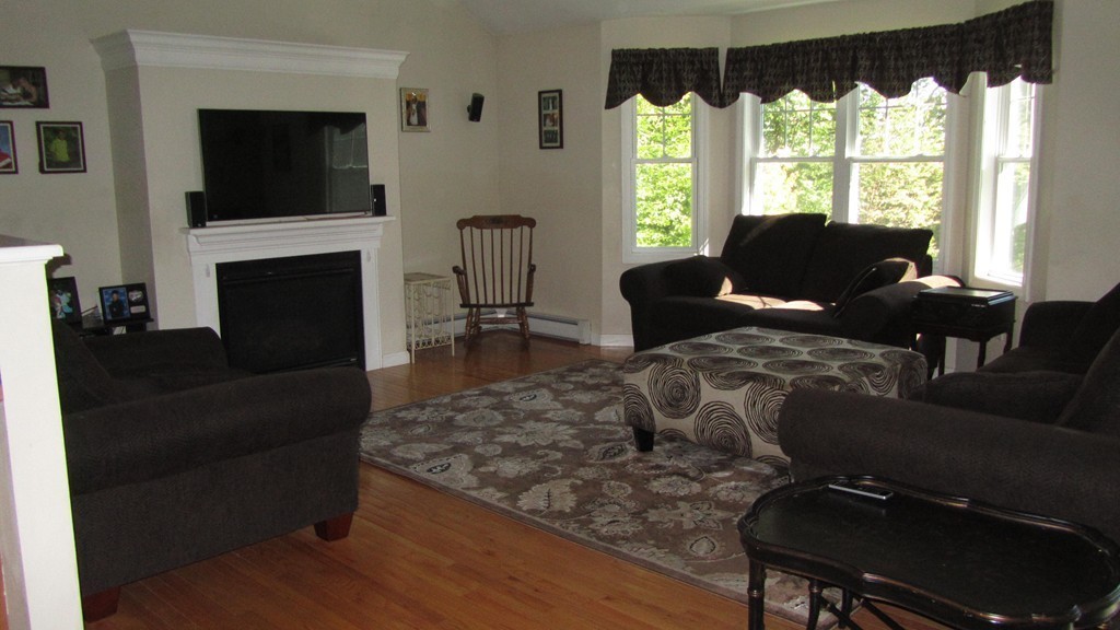 194 Turkey Hill Road Rutland, MA 01543 - Photo 7 of 20 a living room with furniture a flat screen tv and a fireplace