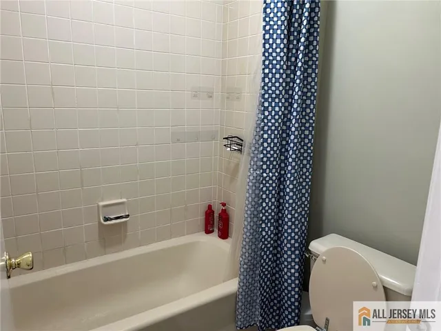 a bathroom with a bathtub and toilet