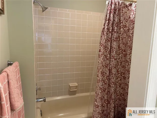 a bathroom with a shower curtain and a sink
