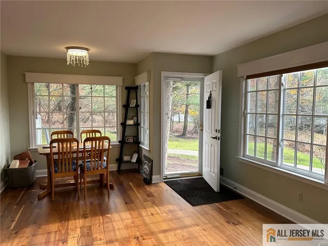 a dining room with furniture and wooden floor