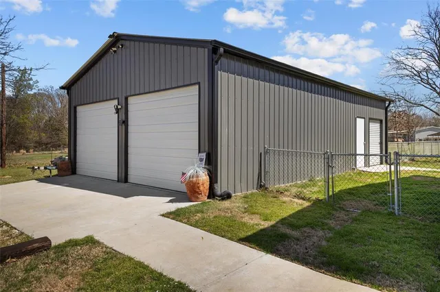 a backyard of a house with plants and outdoor seating