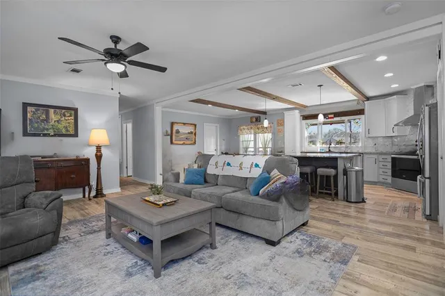 a living room with furniture and kitchen view