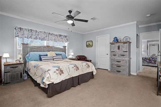 a spacious bedroom with a bed and a chandelier