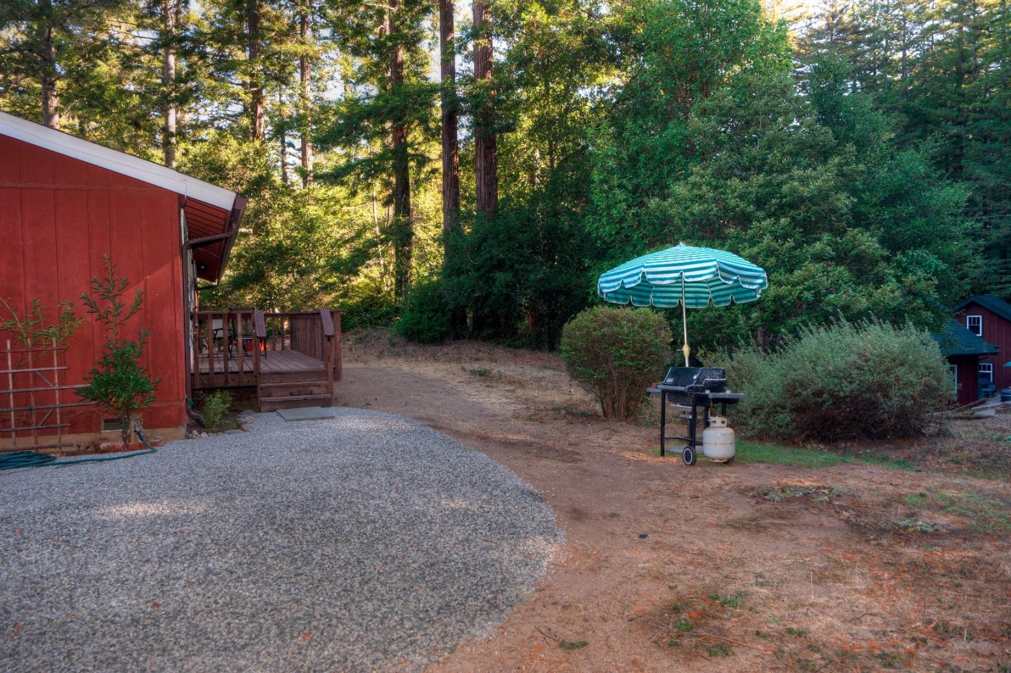 560 Wurr Road Loma Mar, CA 94021 - Photo 3 of 31 a view of a outdoor with a table and chairs under an umbrella