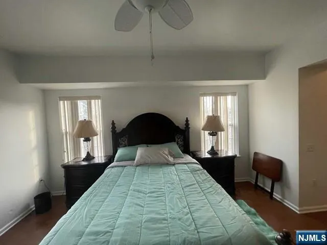 a bedroom with a large bed and a chandelier