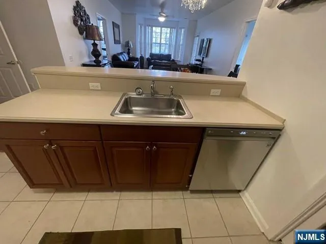 a view of kitchen with stainless steel appliances a sink dishwasher and a refrigerator